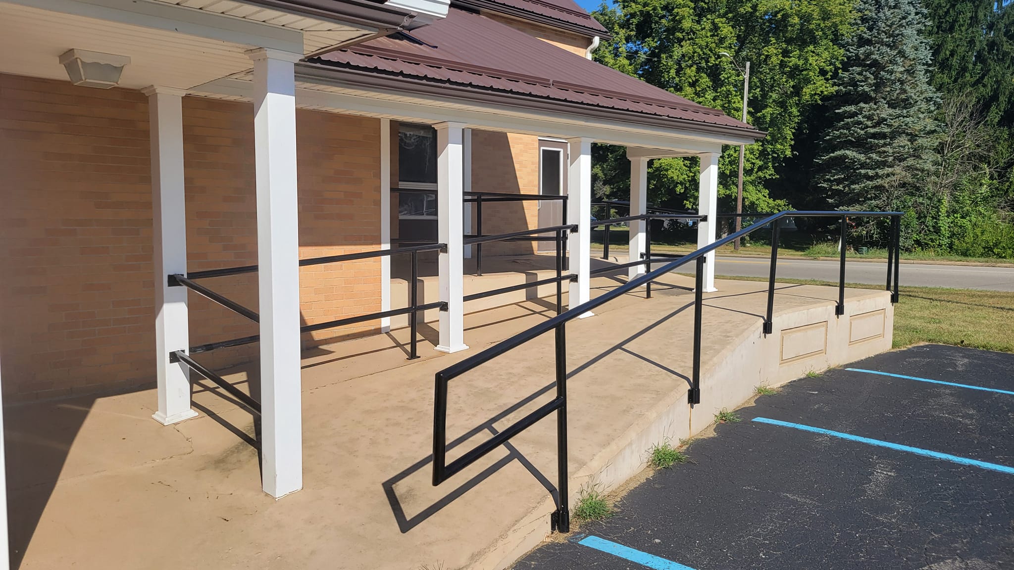 Church entrance with accessibility ramp and covered porch