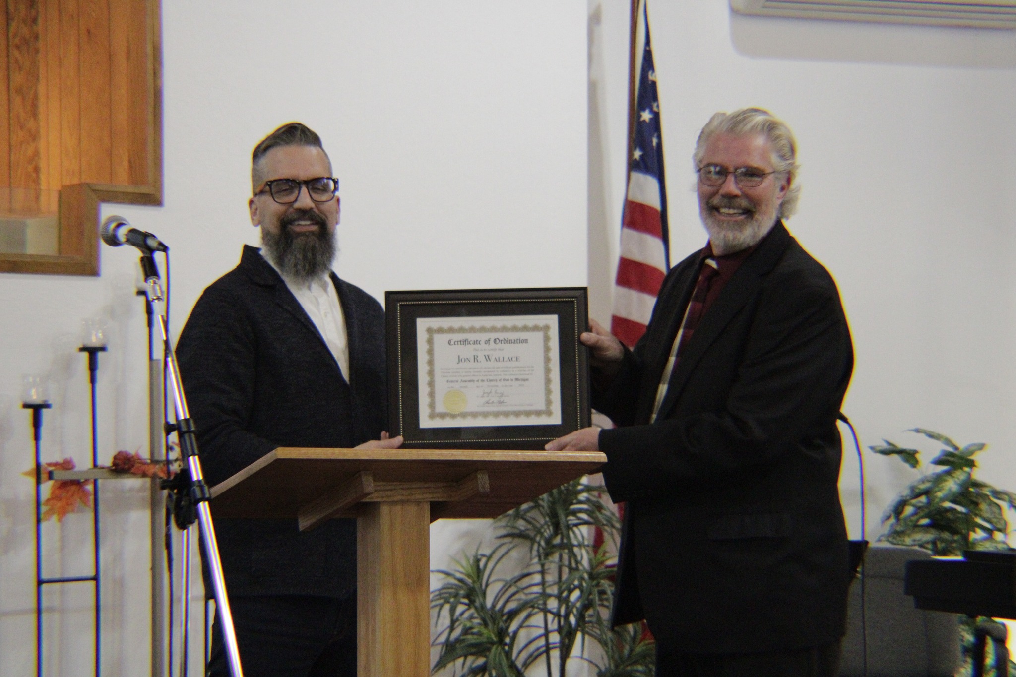 Pastor Jon Wallace receiving his ordination certificate